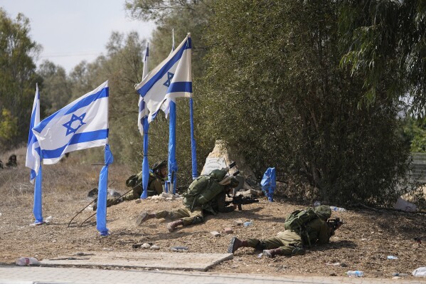 Israeli soldiers take positions in kibbutz Kfar Azza on Tuesday, Oct. 10, 2023. Hamas militants overran Kfar Azza on Saturday, where many Israelis were killed and taken captive. (AP Photo/Ohad Zwigenberg)